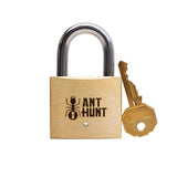 Front view of the Ant Hunt trick lock alongside its brass key, a solid brass puzzle and a good gift for someone who is hard to shop for.