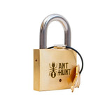 Close-up of the engraved Ant Hunt brass padlock. This clever intermediate-level trick lock is a fantastic interactive centerpiece for family game nights, social gatherings, or coffee table entertainment.
