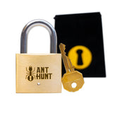 The Ant Hunt mechanical puzzle lock shown with its included black Puzzlocks Fabric Bag. A complete, heirloom-quality gift package ready for anyone who loves mechanical design and lateral logic.