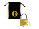 The B-Lock trick lock shown next to its included black fabric carrying bag, ready to wrap as a gift.