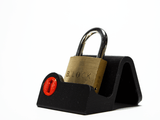 The B-Lock puzzle lock resting on a black display stand, a simple way to keep it out on a desk or shelf.