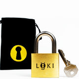 The Loki by Boaz Feldman shown with its fabric bag, a heavy brass puzzle built for solvers who want a real, hours-long challenge.