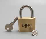 Loki brass puzzle lock with its Jury 1st Prize award pin, Nob Yoshigahara Puzzle Design Competition, IPP Prague 2022.