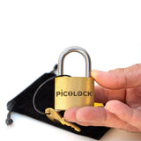 A hand holding the 40mm wide PicoLock to show its pocket-sized scale, small enough to carry anywhere.