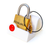 The PicoLock sequential discovery puzzle on a white display stand, a compact brass puzzle and an unexpected gift for gadget lovers.