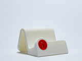 A sleek white Puzzlocks Display Stand accessory. These custom-fit docks are included free in the full set bundle, offering a clean setup to display your solved challenges.
